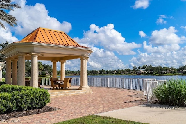 view of patio with a gazebo and a water view