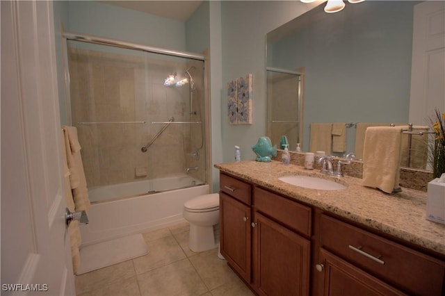 full bathroom featuring tile patterned floors, toilet, vanity, and combined bath / shower with glass door