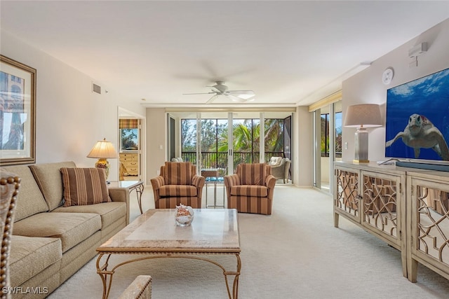 carpeted living room featuring ceiling fan