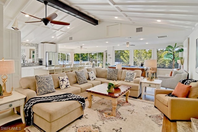 interior space featuring sink and vaulted ceiling with beams