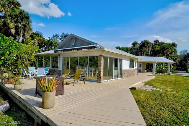 back of property with a yard and a wooden deck