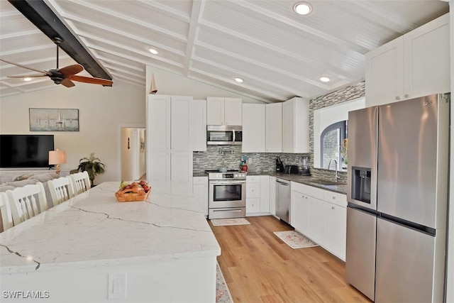 kitchen with sink, white cabinets, tasteful backsplash, and appliances with stainless steel finishes