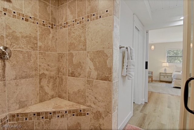 bathroom featuring walk in shower and hardwood / wood-style flooring