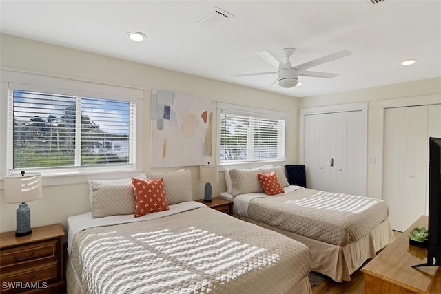 bedroom featuring two closets and ceiling fan