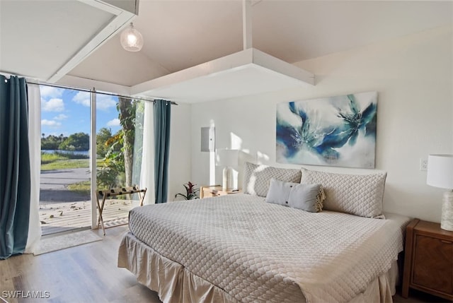 bedroom featuring floor to ceiling windows, light wood-type flooring, and access to exterior