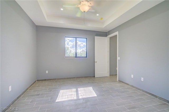 empty room featuring a tray ceiling