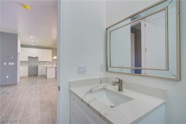 bathroom with tasteful backsplash and sink