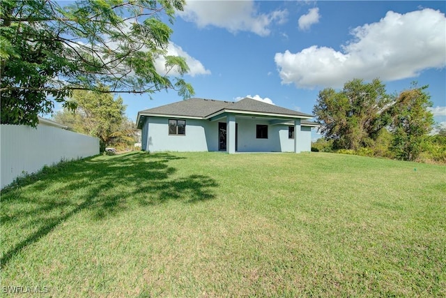 back of house featuring a yard