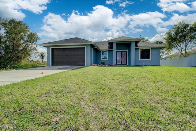 view of front of property featuring a garage and a front lawn