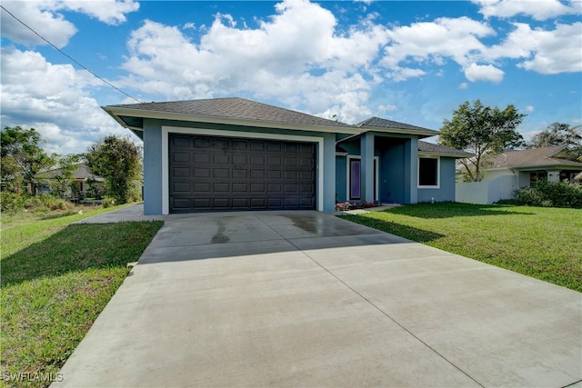 view of front of house with a garage and a front lawn