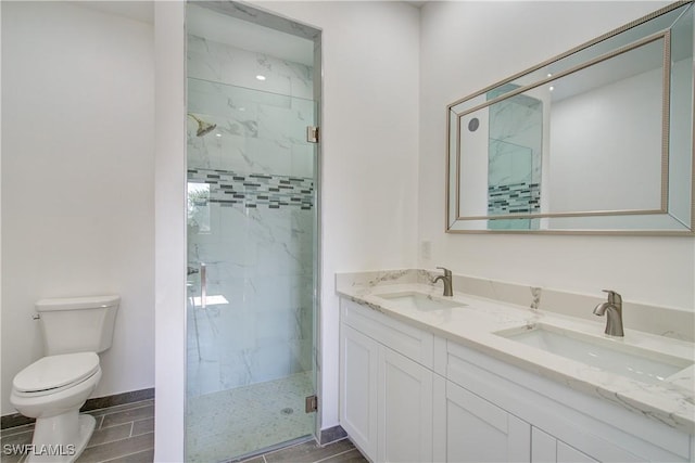 bathroom featuring vanity, toilet, and walk in shower