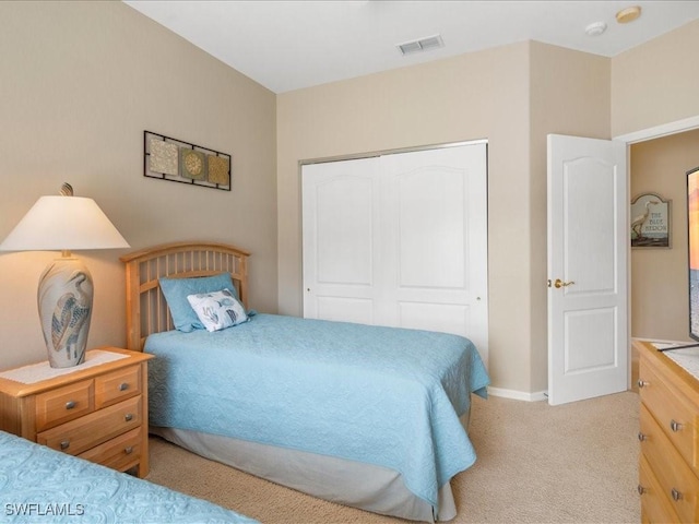 carpeted bedroom featuring a closet