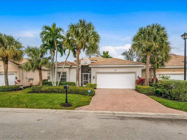 view of front of home featuring a garage and a front lawn