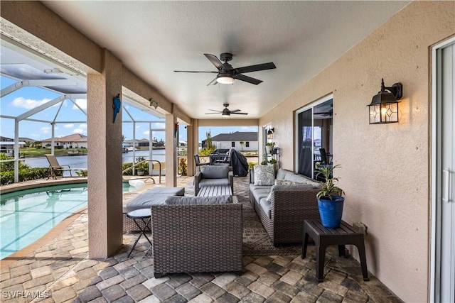 view of patio / terrace featuring an outdoor living space, a water view, ceiling fan, and a lanai