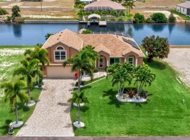 view of front of home with a water view and a front lawn