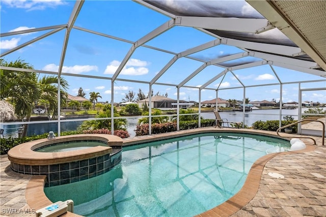 view of pool featuring a lanai, a water view, and an in ground hot tub