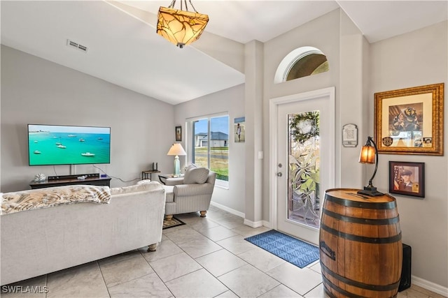 tiled foyer entrance with vaulted ceiling