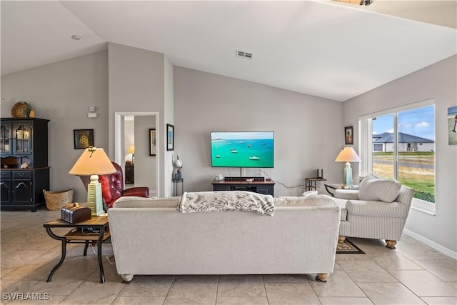 living room featuring light tile patterned floors and vaulted ceiling