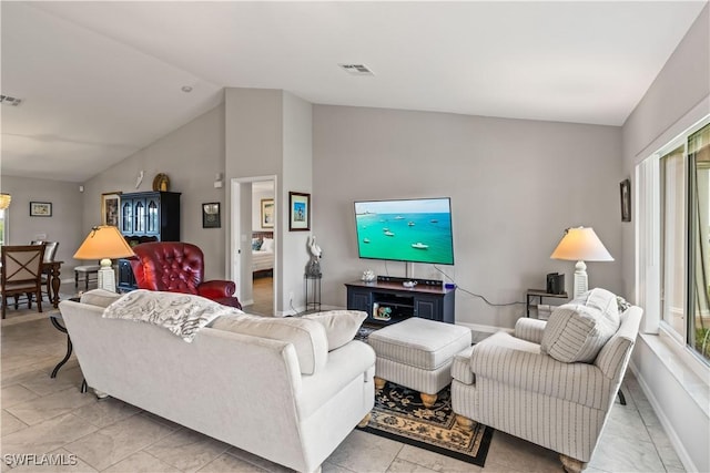 living room featuring plenty of natural light and lofted ceiling