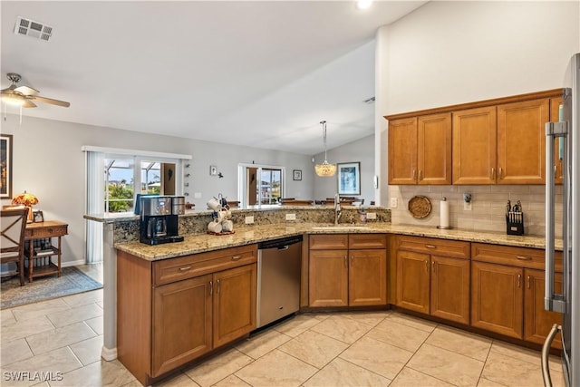 kitchen with sink, kitchen peninsula, decorative light fixtures, vaulted ceiling, and appliances with stainless steel finishes