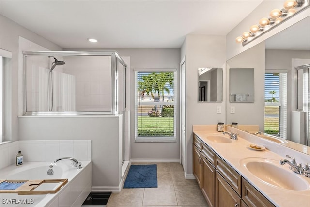 bathroom featuring tile patterned flooring, vanity, and shower with separate bathtub