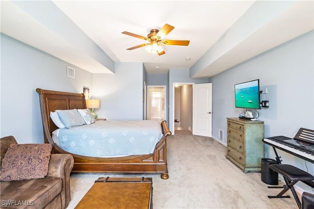 carpeted bedroom featuring ceiling fan and ensuite bath