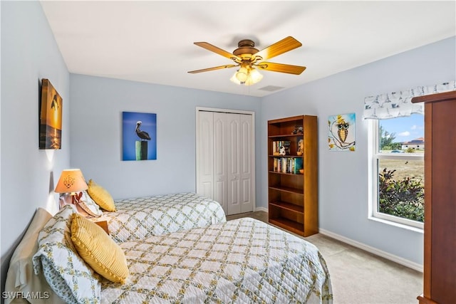 carpeted bedroom with a closet and ceiling fan