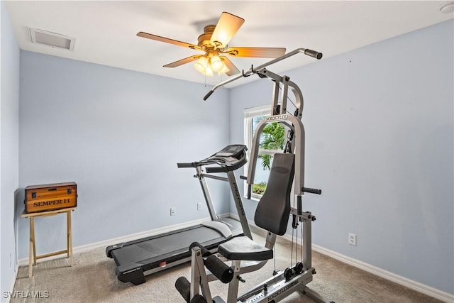 exercise area featuring light carpet and ceiling fan