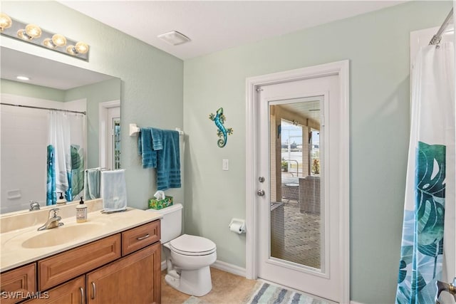 bathroom with toilet, vanity, tile patterned floors, and curtained shower