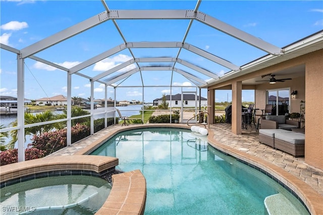 view of swimming pool featuring a lanai, a patio area, a water view, and an in ground hot tub