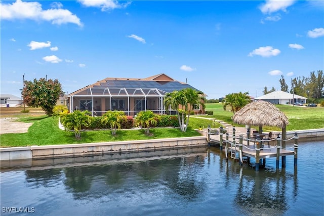 view of dock featuring a water view, glass enclosure, and a lawn