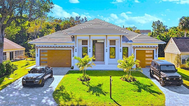 view of front of house featuring a front yard and a garage