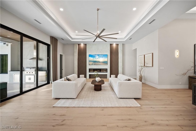 1364 Cypress Woods Dr, Naples, FL 34103 - living area featuring a tray ceiling, light wood finished floors, recessed lighting, baseboards, and ceiling fan