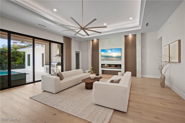 1364 Cypress Woods Dr, Naples, FL 34103 - living room with light wood finished floors, a raised ceiling, a ceiling fan, recessed lighting, and baseboards