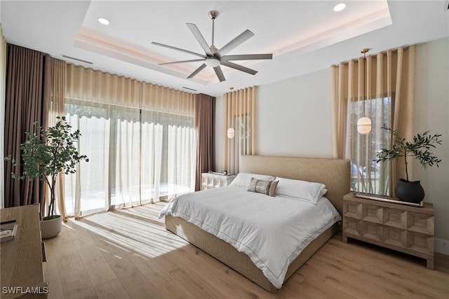 1364 Cypress Woods Dr, Naples, FL 34103 - bedroom with a raised ceiling, wood finished floors, recessed lighting, access to exterior, and a ceiling fan