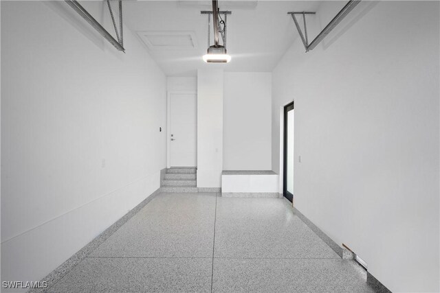 1364 Cypress Woods Dr, Naples, FL 34103 - garage with a garage door opener and baseboards