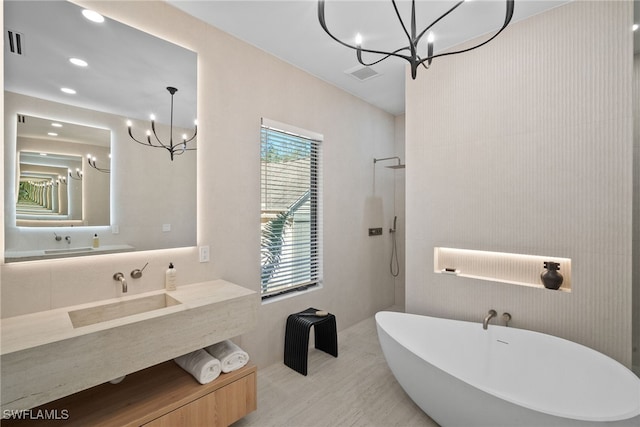 bathroom featuring vanity, plus walk in shower, and an inviting chandelier