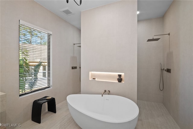 bathroom with shower with separate bathtub