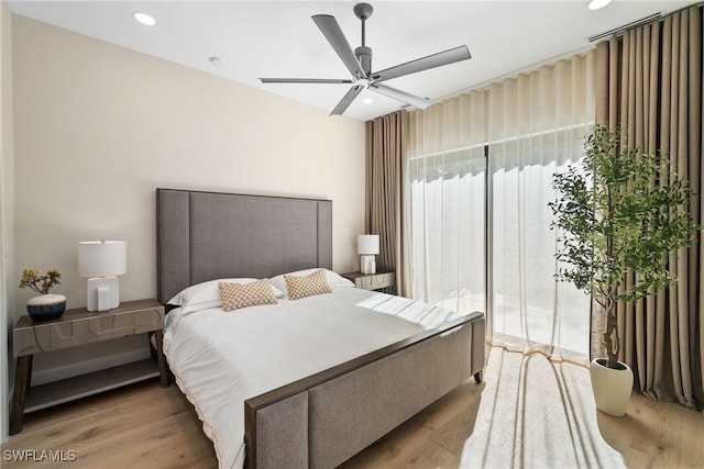 bedroom with ceiling fan and light hardwood / wood-style flooring