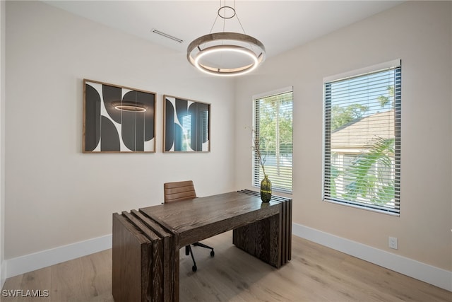 1364 Cypress Woods Dr, Naples, FL 34103 - office area with healthy amount of natural light, baseboards, and light wood-type flooring