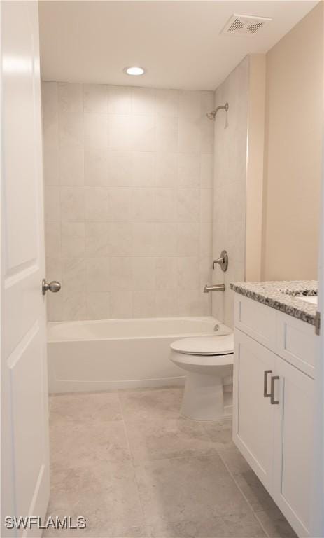 full bathroom featuring vanity, toilet, and tiled shower / bath combo