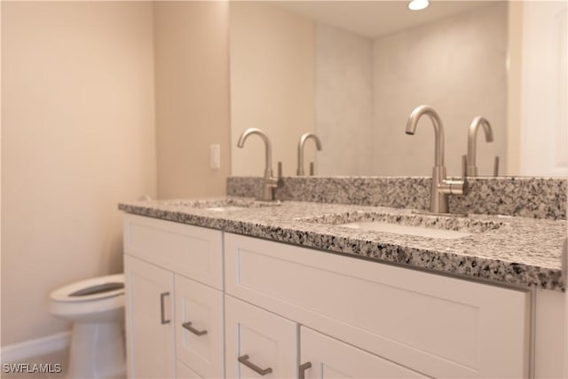 bathroom with vanity and toilet