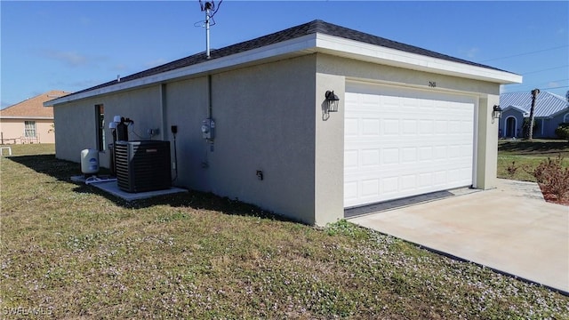 view of side of home featuring a yard, central AC, and a garage