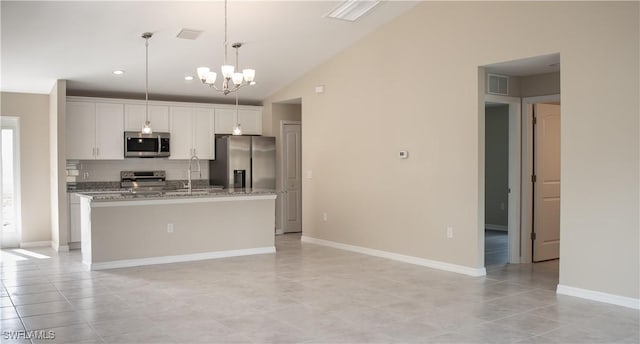 kitchen with a center island with sink, decorative light fixtures, white cabinets, and stainless steel appliances