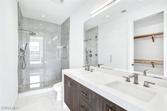 bathroom with walk in shower, vanity, and toilet