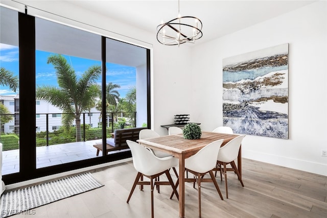 dining room featuring light hardwood / wood-style floors and a chandelier