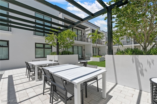 view of patio featuring a balcony and a pergola