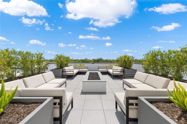 view of patio / terrace with an outdoor living space with a fire pit