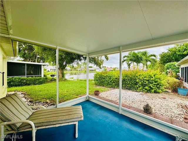 unfurnished sunroom with a water view