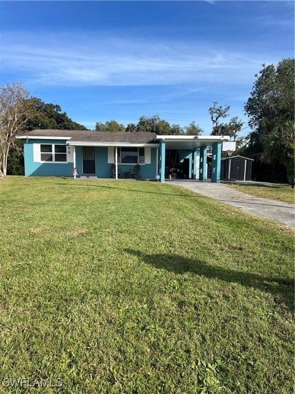 single story home featuring a front lawn and a carport